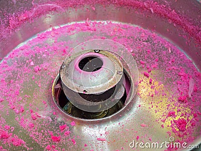 A Fairy floss or Cotton candy sugar machine in close up with pink sugar left over. Stock Photo