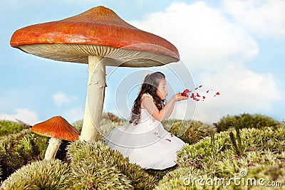 Fairy girl blowing rose petals Stock Photo