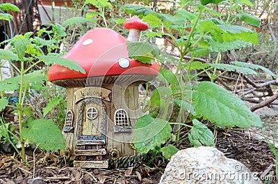 Fairy or Gnome Fantasy Garden Mushroom House Amongst Lemon-balm Melissa officinalis Plants Editorial Stock Photo