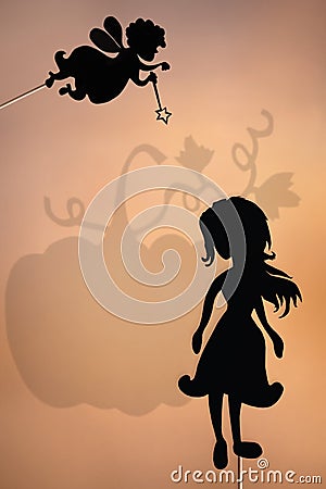 Fairy Godmother and Cinderella shadow puppet and the shade of pumpkin Stock Photo