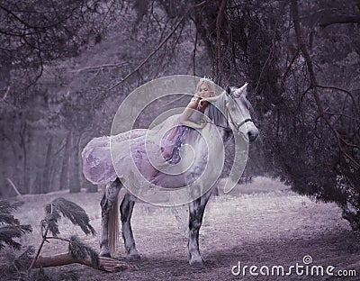 A fairy in a purple, transparent dress with a long flying train lies on a unicorn. Sleeping Beauty. Blonde girl walking Stock Photo