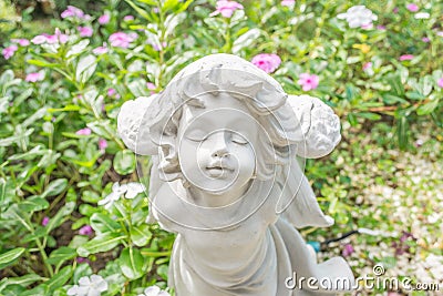 Fairy Statue in the garden with flower Stock Photo