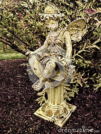 Fairy Statue on pillar in garden Stock Photo