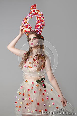 Fairy-tale girl model with floral horns. Stock Photo