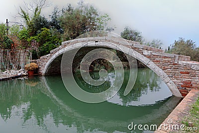 Devil`s bridge over a Venetian Canal, Torcello, Venice, Italy Stock Photo