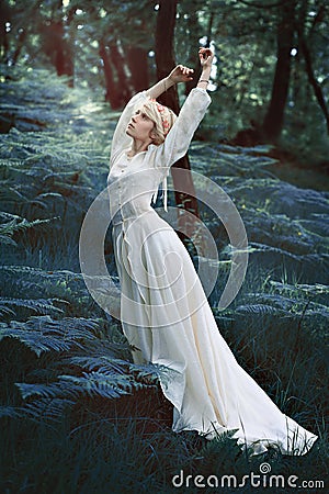 Fairytale woman dancing in forest Stock Photo