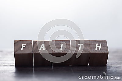 Faith symbol. Turned wooden cube with words Faith. Beautiful white background. Business and Faith concept. Copy space Stock Photo