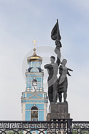 Faith vs. Ideology. A church vs. an ideologically laden monument. Stock Photo