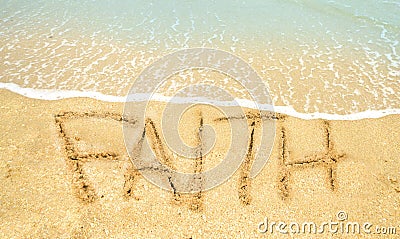 Faith written in sand Stock Photo