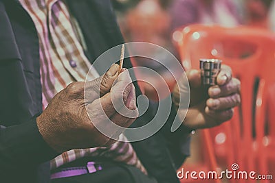 Faithful Asian Elder Praying in the Holy Communion and Praise Jesus Stock Photo