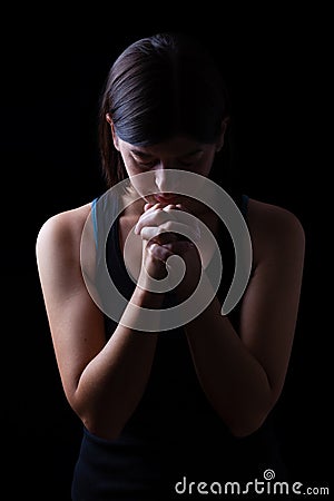 Faithful athletic woman praying Stock Photo