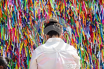 Faithful pray in front of the grid of the church of Senhor do Bonfim on the traditional first Friday of 2023 Editorial Stock Photo