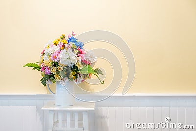 Fake flowers for interior decoration on white wood with cream wa Stock Photo