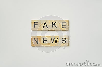 Fake news. Black lettering on wooden plates. Stock Photo