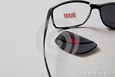 Fake news, disinformation or false information and propaganda concept. . Broken glasses with the inscription Stock Photo