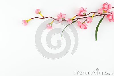 Fake pink flower branches on white background Stock Photo