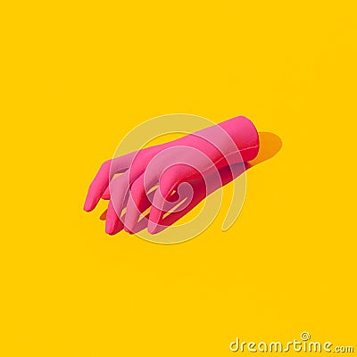 Fake pink hand on yellow background. Fashion still life isometric art Stock Photo