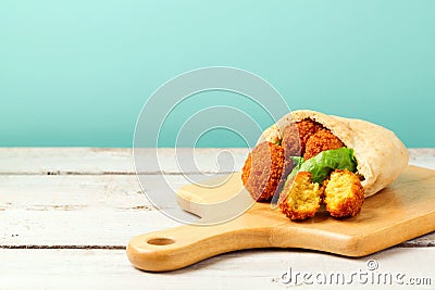 Falafel balls served with pita and lettuce on a wooden board Stock Photo