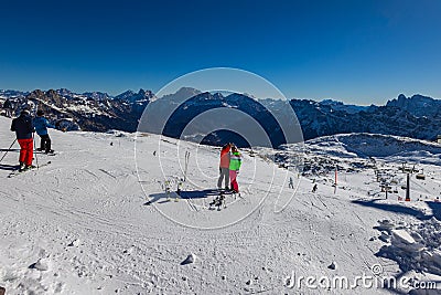 Ski slope with skier under blue sky. People drive down the snowy mountains on skis. Group of Editorial Stock Photo