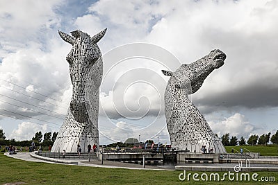 Large statue of The Kelpies, horses heads in Falkirk, Scotland created by Andy Scott with tourist around Editorial Stock Photo