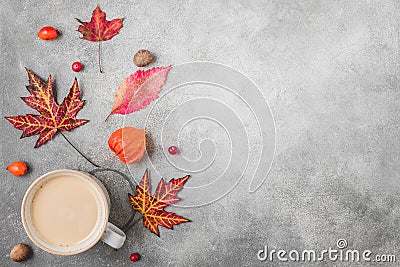 Fall or autumn composition. Coffee cup, autumn leaves, flowers, berries, nuts on concrete background Stock Photo