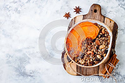 Fall breakfast bowl with cinnamon granola, coconut yogurt, chia seeds and pumpkin puree. Healthy vegan, vegetarian autumn smoothie Stock Photo