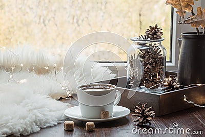 Fall cozy still life on windowsill at home interior. Cup of coffee at home warm fluffy furskin. Hygge. Stock Photo