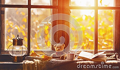 Fall. cozy window with autumn leaves, book, mug of tea Stock Photo