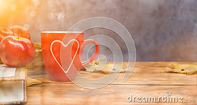 Fall harvest cornucopia. Cup of Hot apple tea for Autumn season warm drink. Stock Photo