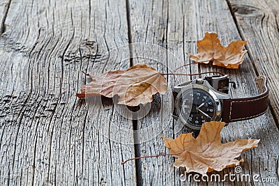 Fall leaf and watch. Seasoning Daylight savings time concept Stock Photo