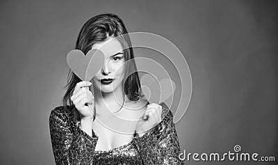 Fall in love. Girl adorable fashion model makeup face hold heart valentines card. Love from first sight. Woman in Stock Photo