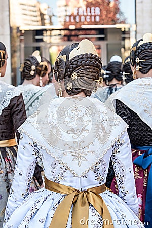 Falleras standing seen from behind. Typical hairstyle of the Valencia holidays celebrated in March Editorial Stock Photo