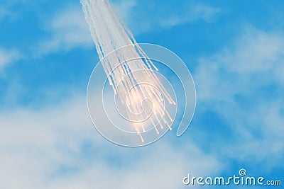 Falling burning flares of several meteorites of asteroids in the day cloudscape sky Stock Photo