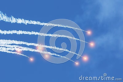 Falling burning flares of several meteorites of asteroids in the day sky Stock Photo