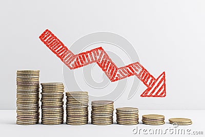 Falling chart of gold coins with red arrow Stock Photo