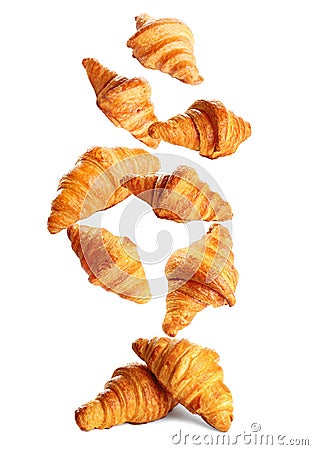 Falling delicious fresh baked croissants on white background. French Stock Photo
