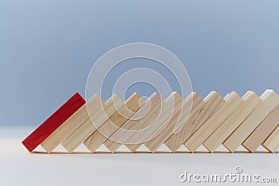 Falling domino blocks, red plank, copy space. Beginning of end. Financial difficulties. Total collapse, economic crisis Stock Photo