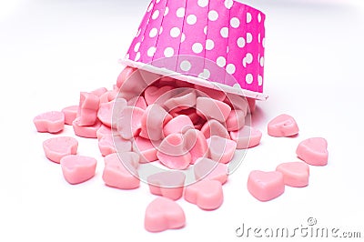 Falling heart candy in Pink polka dot paper cups isolated Stock Photo