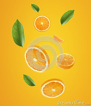 Falling juicy oranges with green leaves on orange background. Flying defocusing slices of oranges. Applicable for fruit juice Stock Photo