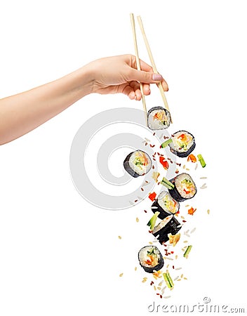 Falling pieces of sushi and sushi roll with wooden chopsticks Stock Photo