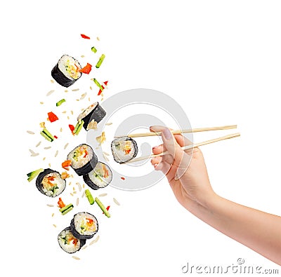 Falling pieces of sushi and sushi roll with wooden chopsticks Stock Photo