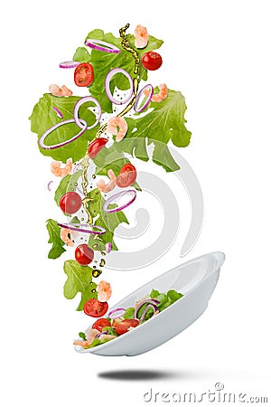 Falling plate with fresh salad Stock Photo