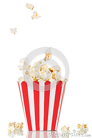 Falling popcorn in large square box and beside her, on white. Stock Photo