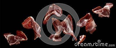 Falling sliced bacon isolated on black background Stock Photo