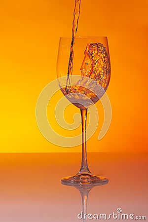 Falling water flow into wineglass and creating a human head silhouette. Stock Photo
