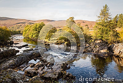 Falls of Dochart a sunny day run through the small town of Killin in Perthshire, Scotland Stock Photo