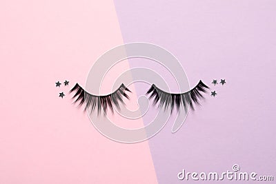 False eyelashes and sparkles on color background Stock Photo