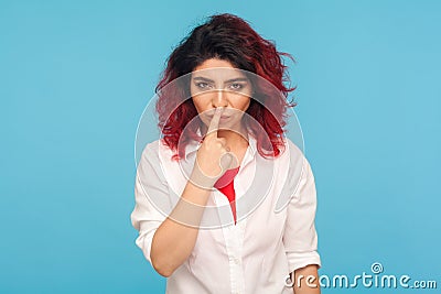 Falsehood sign. Portrait of angry displeased woman with fancy red hair in white shirt touching nose with lie gesture Stock Photo