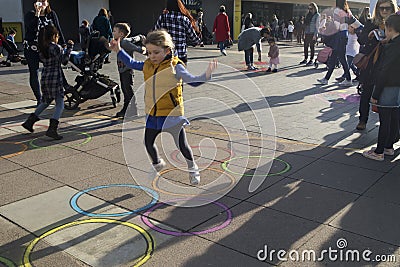 Families with kids playing on an art installation outside the Royal Festival Hall in South bank Editorial Stock Photo