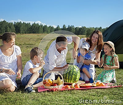 Families picnic outdoors Stock Photo